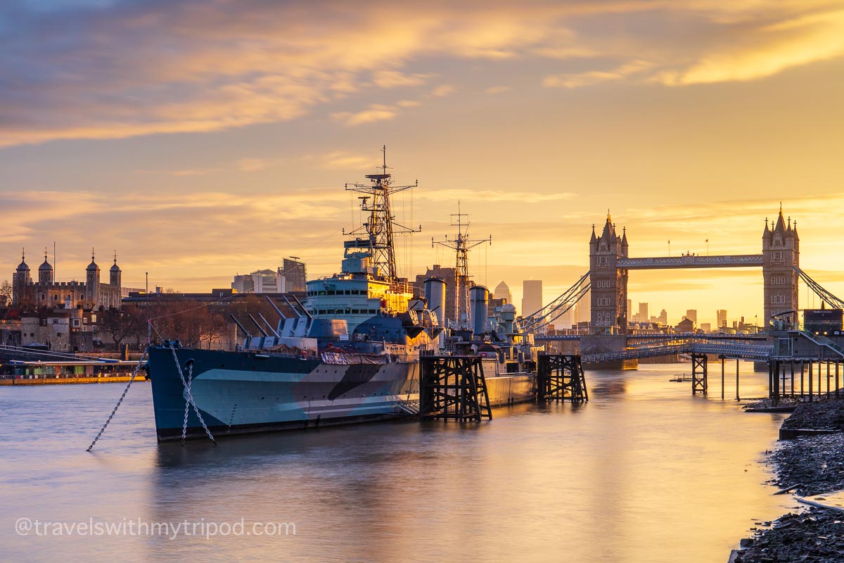HMS Belfast with Tower Bridge in the background at sunrise