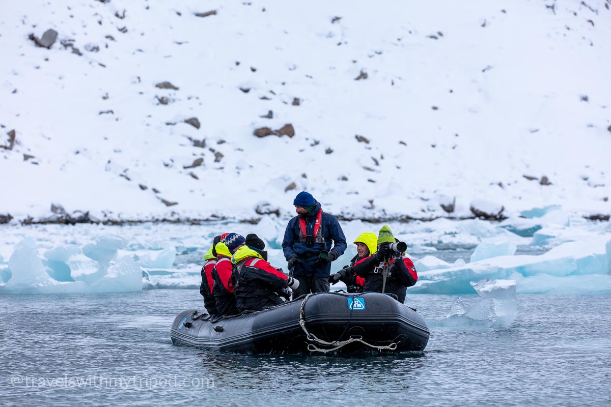 Photographers in a Zodiac boat in Svalbard Photographers in a Zodiac boat in Svalbard